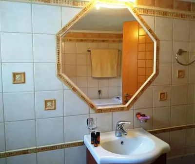 a bathroom with a sink and a mirror at OLIVE BREEZE in Kissamos