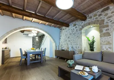a living room with a couch and a table at Kamartsos Villa 2 in Áyios Yeóryios