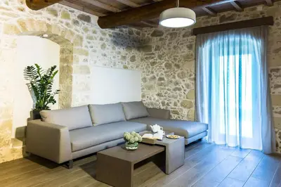 a living room with a couch and a table at Kamartsos Villa 2 in Áyios Yeóryios