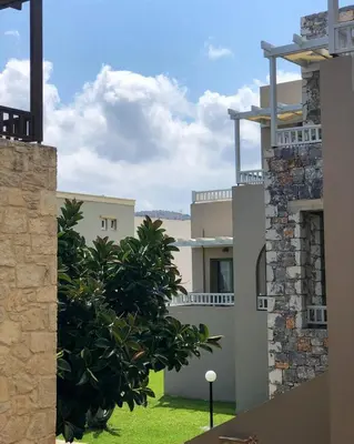 a view from the outside of a house with a tree at Erato Beach Hotel Adults Only by Smile Hotels in Plataniás