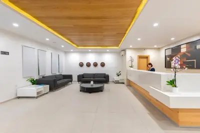 a lobby of a hospital with couches and a table at Erato Beach Hotel Adults Only by Smile Hotels in Plataniás
