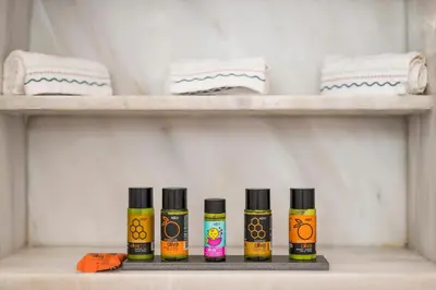 four bottles of essential oils sitting on a shelf at Veranda house in Chania Town