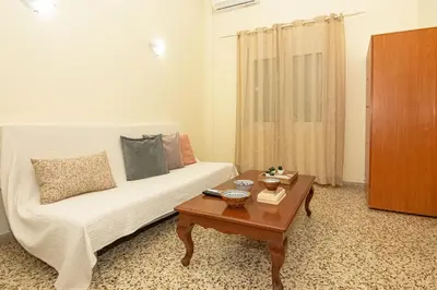 a living room with a couch and a coffee table at Veranda house in Chania Town