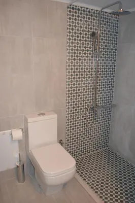 a bathroom with a shower with a toilet and a shower at Kalypso Studios & Rooms in Palaiochóra
