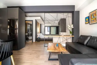 a living room with a couch and a table at MOS Luxury City Suites - The Loft in Chania Town