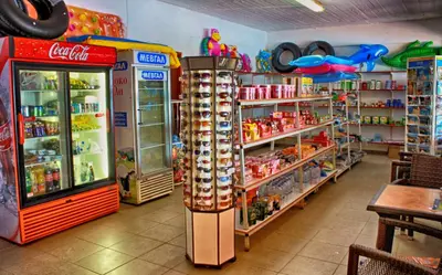 a store with a coca cola refrigerator and a restaurant at Camping Nopigia in Kissamos