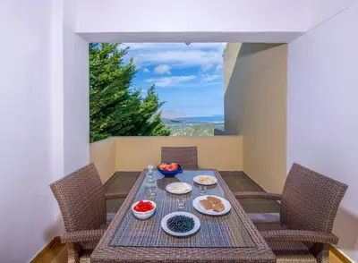a table with plates of food on top of a balcony at Malathiros Traditional Villas in Maláthiros