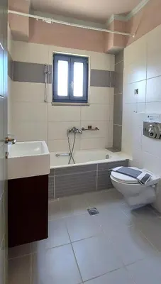 a bathroom with a tub and a toilet and a sink at Villa 