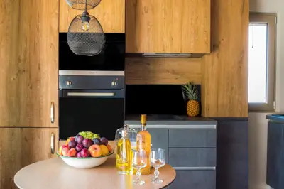 a kitchen with a bowl of fruit on a table at INO I, sea goddess domus jacuzzi by Amigdalokefali Elafonissi in Kissamos
