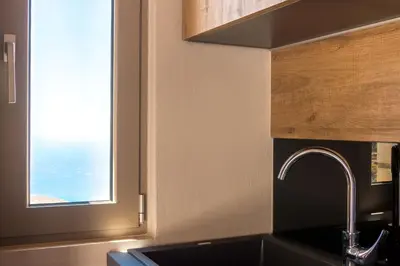 a kitchen with a sink and a window at INO I, sea goddess domus jacuzzi by Amigdalokefali Elafonissi in Kissamos
