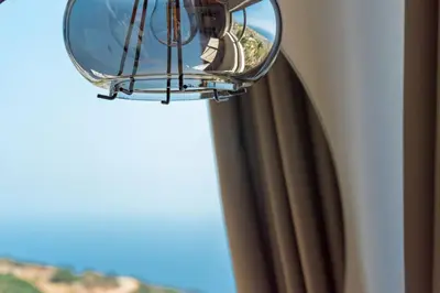 a mirror on the side of a window at INO I, sea goddess domus jacuzzi by Amigdalokefali Elafonissi in Kissamos