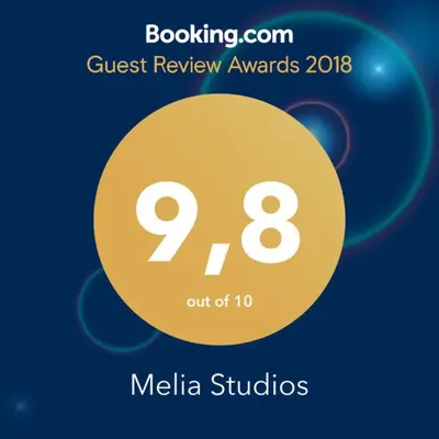 a yellow circle with the words quest review awards and media studios at Melia Studios in Kato Daratso