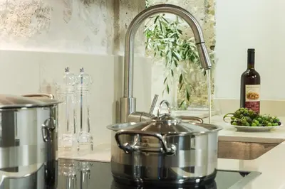a kitchen counter with two pots and a sink at Kamartsos Villa 3 in Áyios Yeóryios