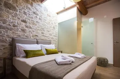 a bedroom with a bed with towels on it at Kamartsos Villa 3 in Áyios Yeóryios