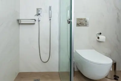 a bathroom with a toilet and a glass shower at Kamartos Villa 1 in Áyios Yeóryios