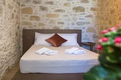 a bedroom with a bed with towels on it at Kamartos Villa 1 in Áyios Yeóryios