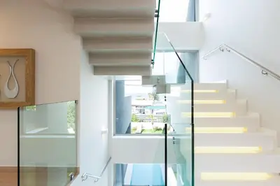 a staircase in a house with a glass railing at Sissy Luxury Villa Chania in Plataniás