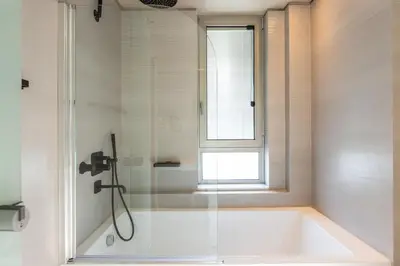 a bathroom with a bath tub and a window at Sissy Luxury Villa Chania in Plataniás