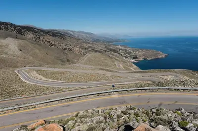 an aerial view of a road on a hill with the ocean at ARADENA TRADITIONAL House 3 in Arádhaina