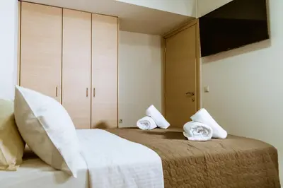 a bedroom with a bed with towels on it at Lazaretta studio in Chania Town