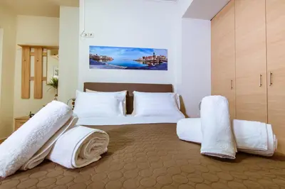 a bedroom with two beds with white pillows at Lazaretta studio in Chania Town
