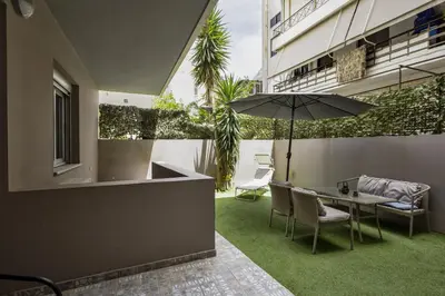 a patio with a table and chairs and an umbrella at Lazaretta studio in Chania Town