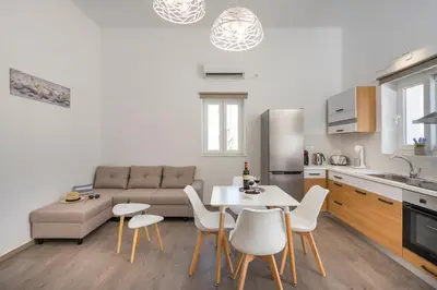 a kitchen and living room with a table and chairs at B&M HOUSE,SIRILI,PLATANIAS in Metókhion Sirilíou