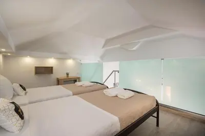 a bedroom with two beds and a glass wall at B&M HOUSE,SIRILI,PLATANIAS in Metókhion Sirilíou