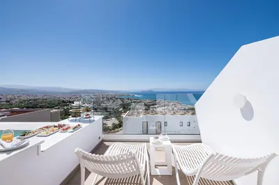 a balcony with white chairs and a view of the city at Lagon Life Spirit Boutique Hotel - Adults Only in Chania Town