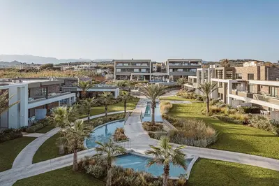 an aerial view of a resort with a pool and palm trees at Myrion Beach Resort & Spa - Adults Only in Gerani Chanion
