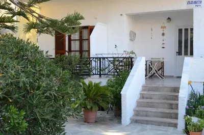 a house with a staircase leading to the front door at Paleochora Elizabeth Apartments in Palaiochóra