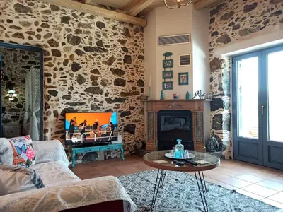 a living room with a stone wall at Polios in Avdhoulianá