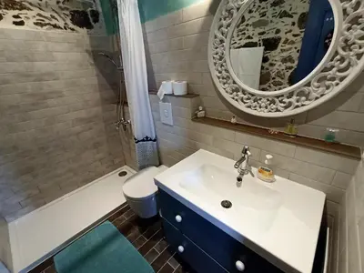 a bathroom with a sink and a toilet and a mirror at Polios in Avdhoulianá