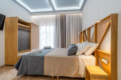 a bedroom with a large bed and a window at Manos Studios in Palaiochóra