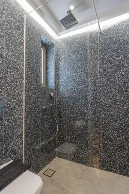 a bathroom with a glass shower with a toilet at Manos Studios in Palaiochóra
