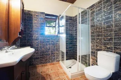 a bathroom with a toilet and a shower and a sink at Villa Talos in Palaiochóra