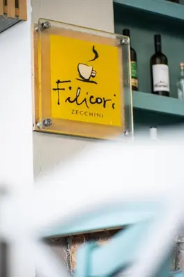 a sign for a liquor restaurant on a shelf at Livikon by the Sea in Khóra Sfakíon