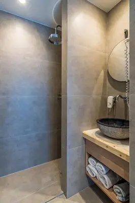 a bathroom with a sink and a shower at Livikon by the Sea in Khóra Sfakíon