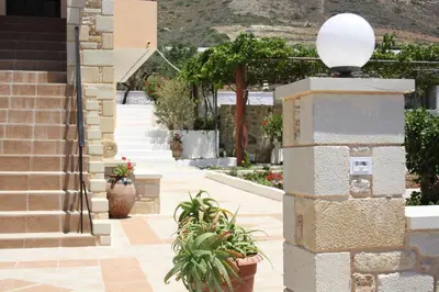 a stairway with potted plants and a building at Romantica Apartments in Falasarna