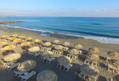 an overhead view of a beach with chairs and umbrellas at Alexia Beach Hotel in Agia Marina Nea Kydonias