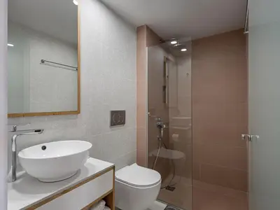 a bathroom with a sink and a toilet and a shower at Alexia Beach Hotel in Agia Marina Nea Kydonias