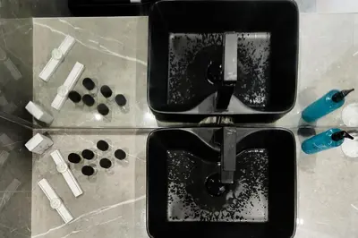 a close up of a bathroom sink with tooth brushes at Galini Palace in Kolymvari