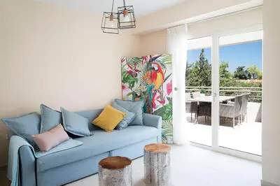 a blue couch in a living room with a patio at LOTOS - Luxury Apartments in Kounoupidhianá