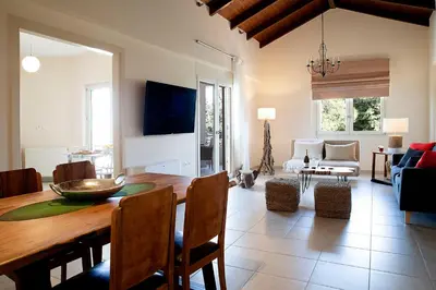 a living room with a table and a dining room at LOTOS - Luxury Apartments in Kounoupidhianá