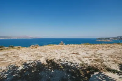 a shadow of a person on a beach at Karavos View - An artists' hideaway Paradise in Kalyves
