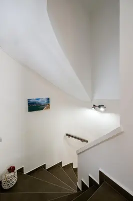 a staircase in a house with white walls at Home with Courtyard in Beating Heart of old Town! in Chania Town