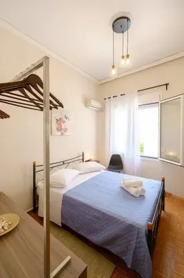 a bedroom with a large bed with a blue blanket at Home with Courtyard in Beating Heart of old Town! in Chania Town
