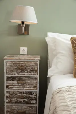 a bedroom with a bed and a nightstand with a lamp at Boutique Home -Splantzia-Roof Garden in Chania Town