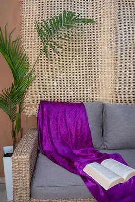 a purple blanket sitting on a couch with a book at Boutique Home -Splantzia-Roof Garden in Chania Town