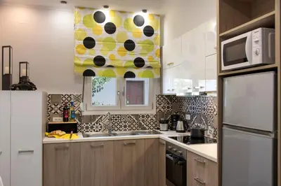 a kitchen with a sink and a microwave at Chania Design Suites in Chania Town